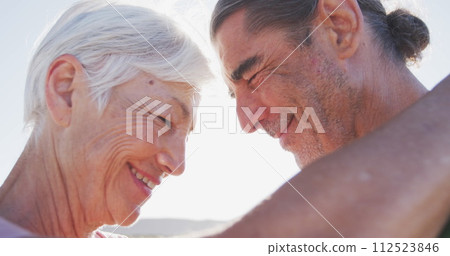 Caucasian couple enjoying a sunny outdoor setting, with copy space 112523846