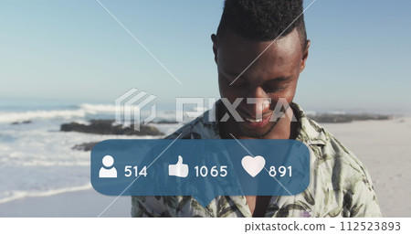 Image of people, thumbs up and heart icons over smiling man using smartphone on beach Image of people, thumbs up and heart icons over smiling man using smartphone on beach 112523893