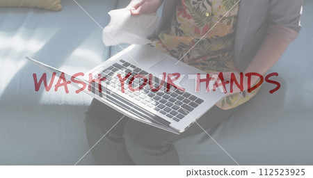 Image of flashing words with woman disinfecting her laptop 112523925