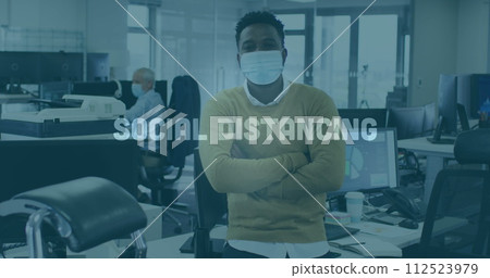 Image of words flashing with colleagues in office wearing face masks 112523979