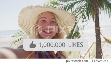 Image of speech bubble with thumbs up icon and numbers over smiling woman on beach 112524044