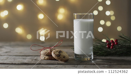 A glass of milk and cookies on a wooden table, with copy space A glass of milk and cookies on a wooden table, with copy space 112524362