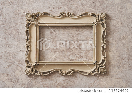Antique picture frame hanging on marble background Antique picture frame hanging on marble background 112524602