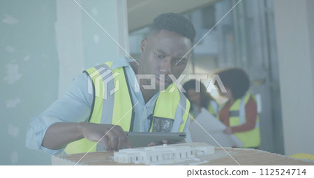 Image of data processing over biracial male engineer in hi vis vest with 3d building model Image of data processing over biracial male engineer in hi vis vest with 3d building model 112524714