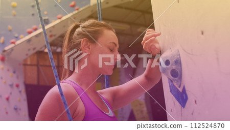 Caucasian fit woman with rope about to climb a wall at gym 112524870