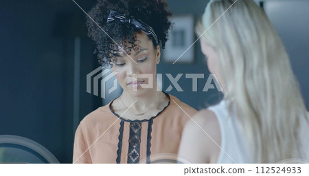 Image of padlock icons data processing over diverse businesswomen in office 112524933