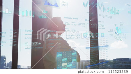 Image of financial data with icons over caucasian businessman in office 112525289