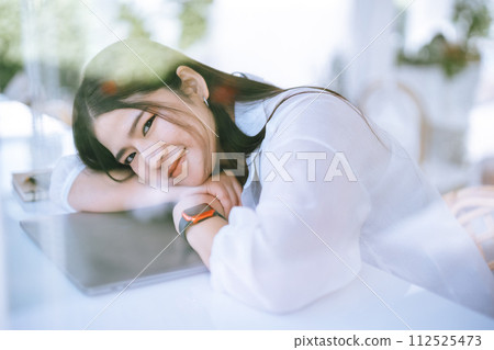 modern portrait of beautiful happy asian woman traveler wearing smartwatch wearing beautiful white dress and wear jeans lifestyle enjoying in sitting coffee shop restaurant background modern portrait of beautiful happy asian woman traveler wearing smartwatch wearing beautiful white dress and wear jeans lifestyle enjoying in sitting coffee shop restaurant background 112525473