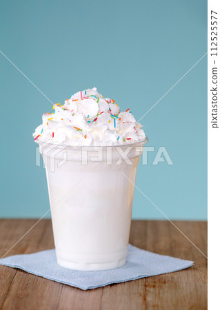 Extreme milkshakein plastic cup blue background Extreme milkshakein plastic cup blue background 112525577