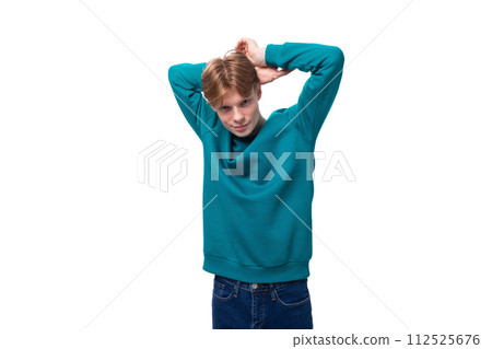 young authentic handsome man with red hair wearing a blue sweater 112525676
