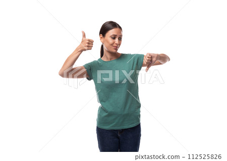attractive young caucasian woman with black hair in a t-shirt actively gesturing on a white 112525826