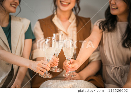 Women, colleagues, female friends, and mom friends toasting with champagne glasses Women, colleagues, female friends, and mom friends toasting with champagne glasses 112526692
