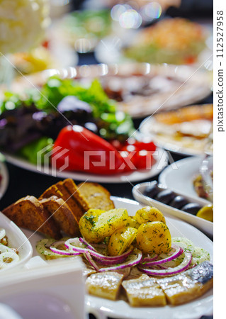 Banquet table with black tablecloth served with appetizers. vegetables 112527958