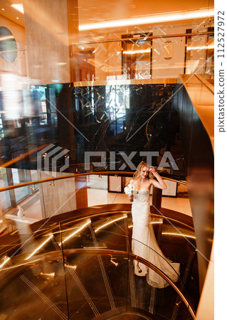 Bride on a golden spiral staircase. Bride on a golden spiral staircase. 112527972