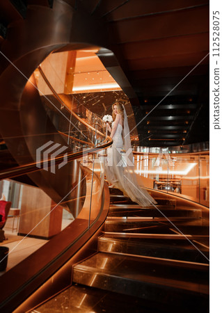 Bride on a golden spiral staircase.  112528075