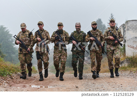 A disciplined and specialized military unit, donned in camouflage, strategically patrolling and maintaining control in a high-stakes environment, showcasing their precision, unity, and readiness for 112528129