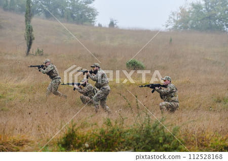 A disciplined and specialized military unit, donned in camouflage, strategically patrolling and maintaining control in a high-stakes environment, showcasing their precision, unity, and readiness for A disciplined and specialized military unit, donned in camouflage, strategically patrolling and maintaining control in a high-stakes environment, showcasing their precision, unity, and readiness for 112528168