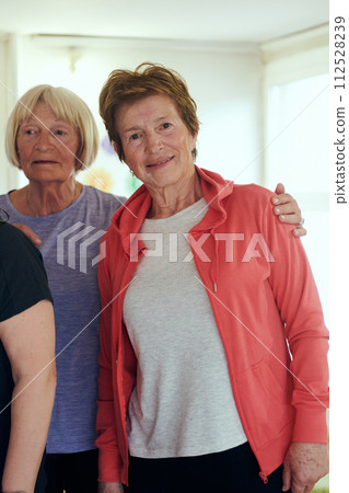 A vibrant community of senior women, guided by their instructor, embraces the enriching journey of yoga, fostering unity, well-being, and a shared commitment to active aging 112528239