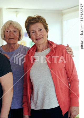 A vibrant community of senior women, guided by their instructor, embraces the enriching journey of yoga, fostering unity, well-being, and a shared commitment to active aging 112528257