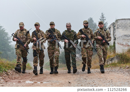 A disciplined and specialized military unit, donned in camouflage, strategically patrolling and maintaining control in a high-stakes environment, showcasing their precision, unity, and readiness for A disciplined and specialized military unit, donned in camouflage, strategically patrolling and maintaining control in a high-stakes environment, showcasing their precision, unity, and readiness for 112528266