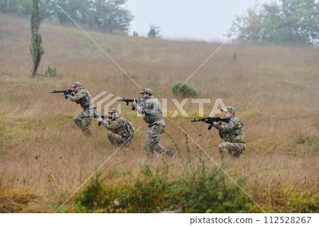 A disciplined and specialized military unit, donned in camouflage, strategically patrolling and maintaining control in a high-stakes environment, showcasing their precision, unity, and readiness for A disciplined and specialized military unit, donned in camouflage, strategically patrolling and maintaining control in a high-stakes environment, showcasing their precision, unity, and readiness for 112528267