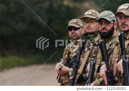 Soldier fighters standing together with guns. Group portrait of US army elite members, private military company servicemen, anti terrorist squad 112528281