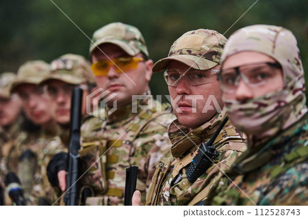 Soldier fighters standing together with guns. Group portrait of US army elite members, private military company servicemen, anti terrorist squad 112528743