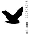Side view silhouette of a flying owl 112528748