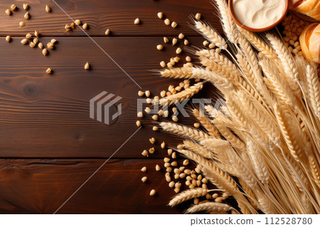 Wheat and buns on a wooden background with copy space. Flat lay 112528780