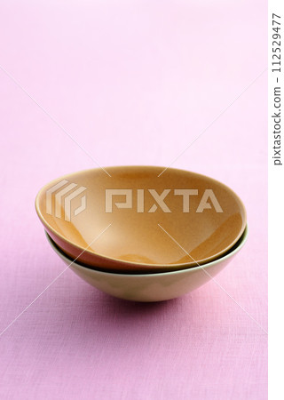 Two different colored vessels stacked on top of each other Two different colored vessels stacked on top of each other 112529477