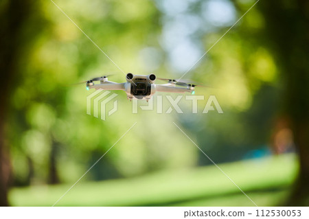 Professional drone filming the park on a sunny day 112530053