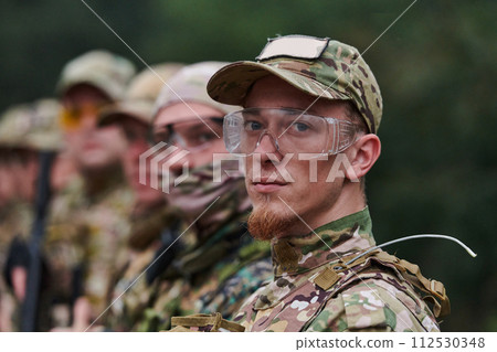 Soldier fighters standing together with guns. Group portrait of US army elite members, private military company servicemen, anti terrorist squad 112530348