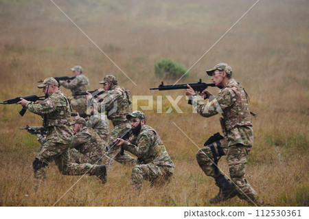 A disciplined and specialized military unit, donned in camouflage, strategically patrolling and maintaining control in a high-stakes environment, showcasing their precision, unity, and readiness for 112530361