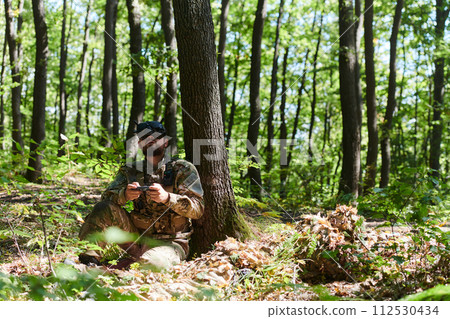 An elite soldier, equipped with state-of-the-art VR glasses, adeptly maneuvers a military drone, showcasing the seamless integration of cutting-edge technology in modern warfare An elite soldier, equipped with state-of-the-art VR glasses, adeptly maneuvers a military drone, showcasing the seamless integration of cutting-edge technology in modern warfare 112530434