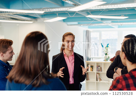A diverse team of young business people exchanging ideas in a modern startup office 112530528