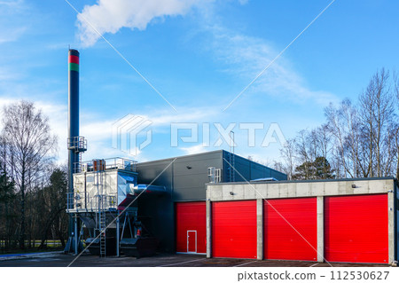 New modern wood chip biofuel boiler house for increased heat energy production efficiency in action New modern wood chip biofuel boiler house for increased heat energy production efficiency in action 112530627