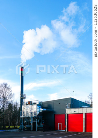 New modern wood chip biofuel boiler house for increased heat energy production efficiency in action 112530628