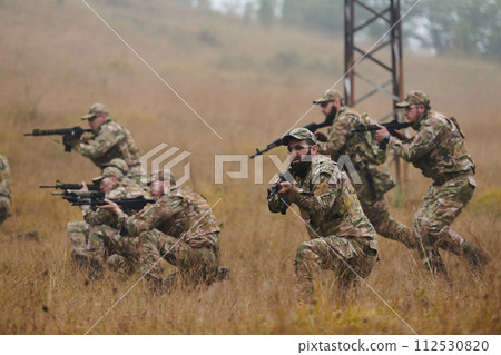 A disciplined and specialized military unit, donned in camouflage, strategically patrolling and maintaining control in a high-stakes environment, showcasing their precision, unity, and readiness for A disciplined and specialized military unit, donned in camouflage, strategically patrolling and maintaining control in a high-stakes environment, showcasing their precision, unity, and readiness for 112530820