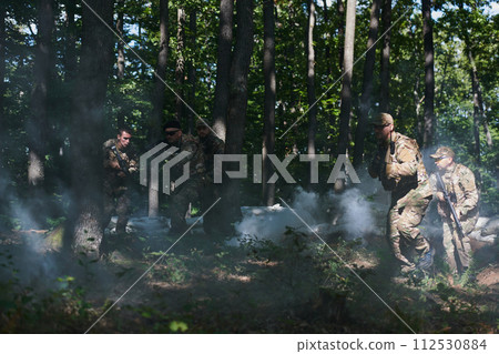A specialized military antiterrorist unit conducts a covert operation in dense, hazardous woodland, demonstrating precision, discipline, and strategic readiness A specialized military antiterrorist unit conducts a covert operation in dense, hazardous woodland, demonstrating precision, discipline, and strategic readiness 112530884