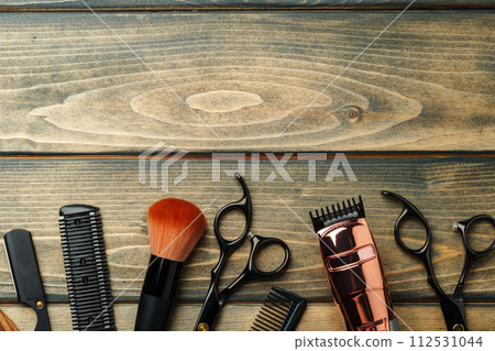 Set of professional barber tools on wooden table Set of professional barber tools on wooden table 112531044