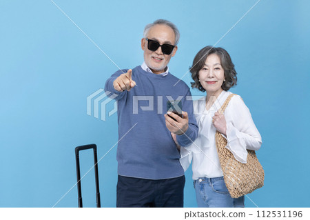 A senior who picks up a smartphone and points out A senior who picks up a smartphone and points out 112531196