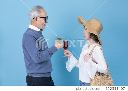A senior holding a wine glass 112531407