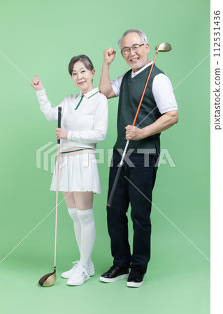 A senior holding a golf club 112531436
