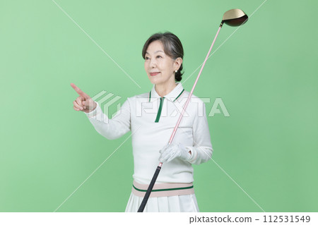 A senior woman holding a golf club A senior woman holding a golf club 112531549
