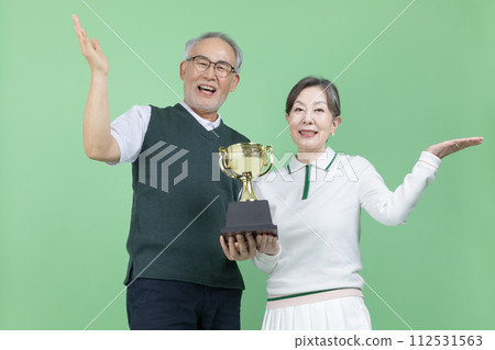 A senior holding a trophy 112531563