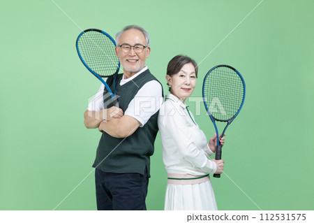 A senior with a tennis racket 112531575