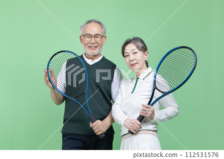 A senior with a tennis racket 112531576