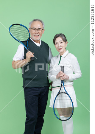 A senior with a tennis racket 112531613
