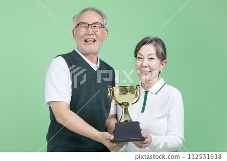A senior holding a trophy 112531638