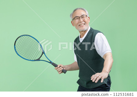 A senior man who plays tennis with a tennis racket A senior man who plays tennis with a tennis racket 112531681